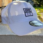 white ball cap with perforated back and Penn State Jax logo